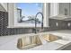 Modern kitchen sink with a black gooseneck faucet and quartz countertops at 7711 N Orleans Ave, Tampa, FL 33604