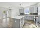 Open concept kitchen and dining area with gray cabinetry and luxury vinyl plank flooring at 7711 N Orleans Ave, Tampa, FL 33604