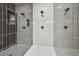 Large walk-in shower with gray tile and built-in shelving at 7711 N Orleans Ave, Tampa, FL 33604