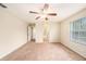 Bright bedroom with window, ceiling fan and access to bathroom at 8110 Hampton View Ln, Tampa, FL 33647