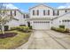 Two-story townhome with attached garage and well-manicured landscaping at 8110 Hampton View Ln, Tampa, FL 33647