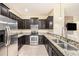 Stainless steel appliances and granite countertops in this kitchen at 8110 Hampton View Ln, Tampa, FL 33647