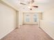 Bright loft area with carpet, ceiling fan and windows at 8110 Hampton View Ln, Tampa, FL 33647