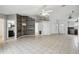 Living room with wood-look accent wall and tile flooring at 9229 Haverford Ln, Port Richey, FL 34668