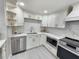 Modern kitchen with white cabinets and marble countertops at 9334 Ledgestone Ln, Port Richey, FL 34668