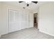 Bedroom featuring a double door closet and wood-look tile floors at 9415 Forest Hills Dr, Tampa, FL 33612