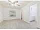 Main bedroom with ceiling fan and access to bathroom at 9415 Forest Hills Dr, Tampa, FL 33612