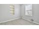 Simple bedroom with grey walls, wood-look floors, built-in shelving, and window at 9415 Forest Hills Dr, Tampa, FL 33612