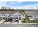 Aerial view of townhouses with parking and a pond at 9642 Sweetwell Pl, Riverview, FL 33569