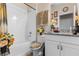 Clean bathroom featuring a bathtub, granite countertop, and white cabinets at 9642 Sweetwell Pl, Riverview, FL 33569