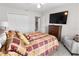 Bedroom with queen-size bed and large TV at 9642 Sweetwell Pl, Riverview, FL 33569