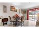 Elegant dining room with glass table and four chairs at 9642 Sweetwell Pl, Riverview, FL 33569