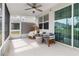 Relaxing screened porch with wicker chairs and ceiling fan at 9642 Sweetwell Pl, Riverview, FL 33569