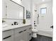 Modern bathroom with gray vanity, white tile, and a shower/tub combo at 108 E Chelsea St, Tampa, FL 33603