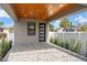 Covered front porch with wood-beamed ceiling and brick pavers at 108 E Chelsea St, Tampa, FL 33603