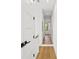 Light-filled hallway with hardwood floors and access to multiple rooms at 108 E Chelsea St, Tampa, FL 33603