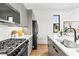 Modern kitchen featuring gray cabinets, stainless steel appliances, and quartz countertops at 108 E Chelsea St, Tampa, FL 33603