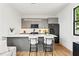 Modern kitchen with gray cabinets, quartz countertops, and stainless steel appliances at 108 E Chelsea St, Tampa, FL 33603