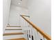 Clean and bright staircase with white risers and wooden handrail at 108 E Chelsea St, Tampa, FL 33603