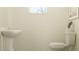 Small half bathroom with pedestal sink and toilet at 10816 Fort White Ct, Tampa, FL 33647