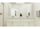 Double vanity bathroom with a large mirror and modern fixtures at 10852 Ibis Brook Ct, Land O Lakes, FL 34638