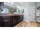 Double vanity bathroom with dark wood cabinets and light flooring at 11036 Paradise Point Way, New Port Richey, FL 34654