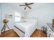 Light and bright bedroom with wood floors and nautical themed decor at 11036 Paradise Point Way, New Port Richey, FL 34654