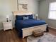 Main bedroom with king-size bed, blue bedding, and nightstands at 11036 Paradise Point Way, New Port Richey, FL 34654