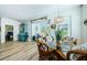 Bright dining area with wicker chairs and glass table at 11036 Paradise Point Way, New Port Richey, FL 34654