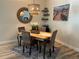 Casual dining area with a wooden table and wicker chairs at 11036 Paradise Point Way, New Port Richey, FL 34654