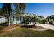 Single Gathering home with landscaped yard and palm trees at 11036 Paradise Point Way, New Port Richey, FL 34654