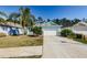 Light blue house with white garage door and palm trees in the front yard at 11036 Paradise Point Way, New Port Richey, FL 34654