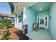 Covered front porch with stone accents and a wooden bench at 11036 Paradise Point Way, New Port Richey, FL 34654