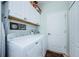 Laundry room with white cabinets and a full-size washer and dryer at 11036 Paradise Point Way, New Port Richey, FL 34654