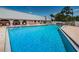 Community pool with lounge chairs and surrounding patio at 11036 Paradise Point Way, New Port Richey, FL 34654