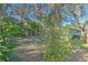 Partially fenced backyard with lush landscaping at 11121 Roberts Ln, Riverview, FL 33578