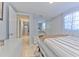 Main bedroom with striped bedding and mirrored closet doors at 11121 Roberts Ln, Riverview, FL 33578