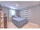 Bedroom with gray walls and blue striped bedding at 11121 Roberts Ln, Riverview, FL 33578