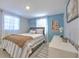 Bedroom with blue walls, striped bedding, and white dresser at 11121 Roberts Ln, Riverview, FL 33578