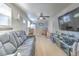 Cozy living room features a black leather sofa and large TV at 11121 Roberts Ln, Riverview, FL 33578