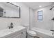 Clean bathroom with white vanity, marble-look shower tile, and modern fixtures at 11882 104Th St, Largo, FL 33773