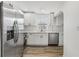 Bright kitchen featuring white shaker cabinets, stainless steel appliances, and wood-look flooring at 11882 104Th St, Largo, FL 33773