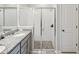 Updated bathroom features a double vanity, granite countertop, and a glass-enclosed shower at 12772 Achasta Blvd, Hudson, FL 34669