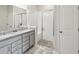 Spa-like bathroom with double vanity, granite countertop and a walk in shower at 12772 Achasta Blvd, Hudson, FL 34669