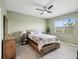 Serene bedroom with a wooden bed frame and plenty of natural light at 12772 Achasta Blvd, Hudson, FL 34669