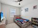 bedroom with a twin bed, bookshelf and plenty of natural light at 12772 Achasta Blvd, Hudson, FL 34669