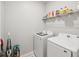 Laundry room with washer, dryer, and shelving at 12772 Achasta Blvd, Hudson, FL 34669