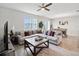 Relaxing living room with sectional sofa, large TV, and wooden coffee table at 12772 Achasta Blvd, Hudson, FL 34669