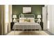 Bedroom with a white metal bed frame and green accent wall at 13582 Newbridge St, Spring Hill, FL 34609