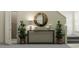 Stylish entryway with console table, mirror, and plants at 13582 Newbridge St, Spring Hill, FL 34609